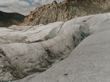 Folds of ice with a sooty crust on a glacier