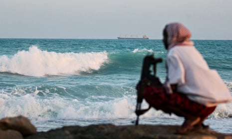An armed pirate keeping vigil on the coastline at Hobyo, northeastern Somalia.