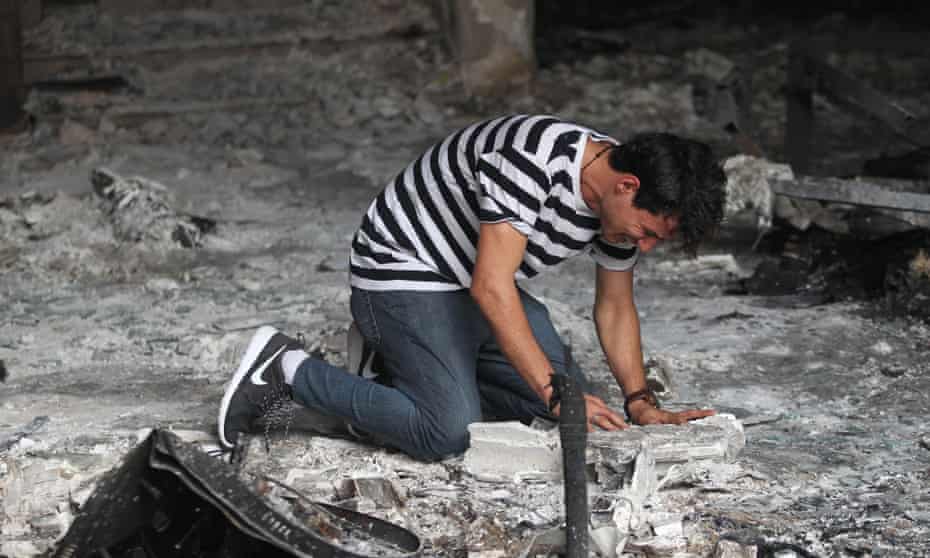 An Iraqi man cries inside a building destroyed by a suicide bombing in Baghdad at the weekend.
