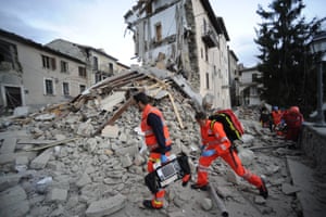 Rescuers search a crumbled building