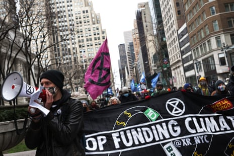 Demonstrators march in New York City on 2 April in solidarity with the #StopTheMoneyPipeline coalition.