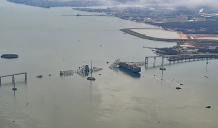 aerial view of a body of water with pieces of a metal bridge submerged