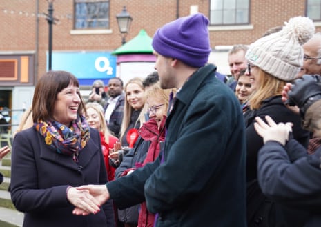 Rachel Reeves shakes a man's hand in a crowd of people
