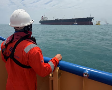 A sailor observes the oil tanker Helga, moored at one of Iraq’s offshore oil terminals near Basra.