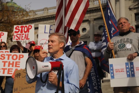 Jim Jordan stands with dozens of people calling for stopping the vote count in Pennsylvania, in Harrisburg on 5 November.