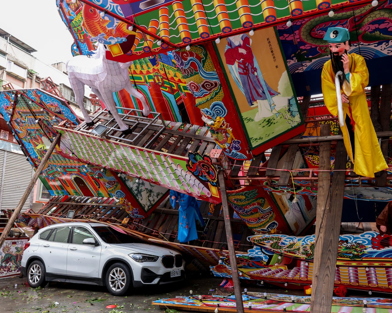 A structure built for a traditional Taoist religious ceremony lies collapsed after being battered by winds