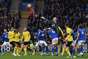 Leicester City’s keeper Kasper Schmeichel jumps to punch the ball clear after a corner.