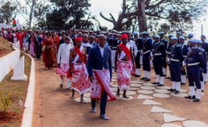 The Prince of Menabe leading a group of people in a procession while guards stand to attention on one side