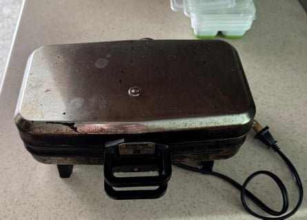 A black and silver waffle-maker