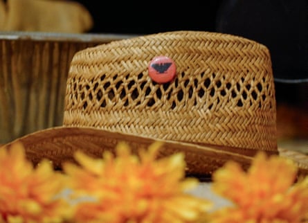 A straw hat with a badge on a table.