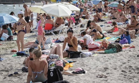 People on a Black Sea beach in Odesa that was reopened after being closed down last year