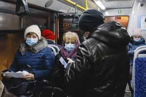 Covid news live: Austria enters nationwide lockdown; Australia eases international border restrictions 4 An employee checks a passenger’s QR code in a bus in Kazan, Russia.