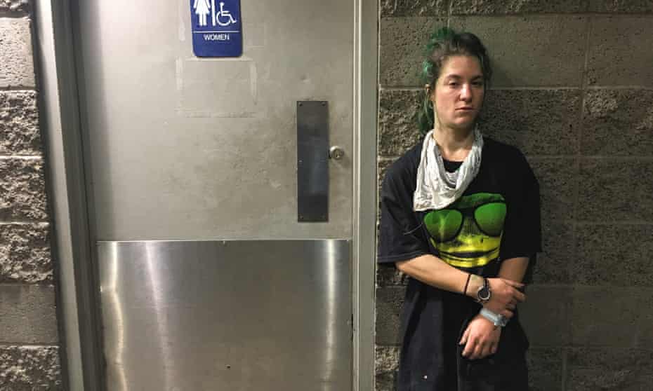 Megan Neidhart, a homeless woman, outside the bathroom. The situation contravenes UN standards for long-term refugee camps, which specify one toilet for 20 people at most.