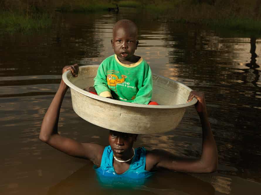 Nyarew Gatluak, 29, carries her baby Tito Beliu, two