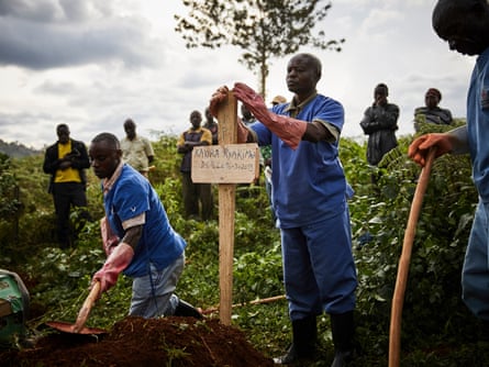 Health workers take part in the funeral of Ebola victims in Butembo, North Kivu province.