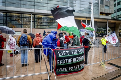Supporters of the ten Palestinian and Dutch civil society organisations suing the Dutch government, gather with flags and banners outside the court of appeal in The Hague, the Netherlands.
