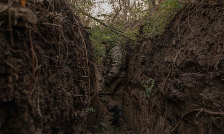 A Ukrainian soldier walks through a trench dug by the Russians in the Zaporizhia region.