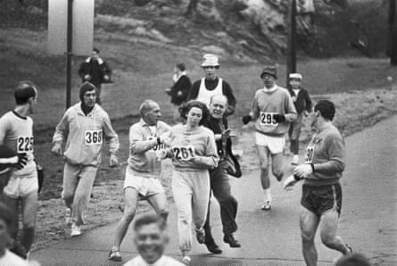 A race official tries to remove Kathrine Switzer from the Boston Marathon, 1967. Male runners move in to form a protective curtain around her