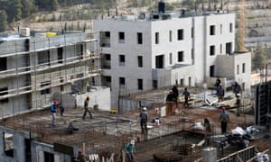 Labourers work at a construction site in the Israeli settlement of Ramot in an area annexed to Jerusalem.