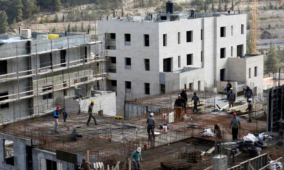 Labourers work at a construction site in the Israeli settlement of Ramot in an area annexed to Jerusalem.