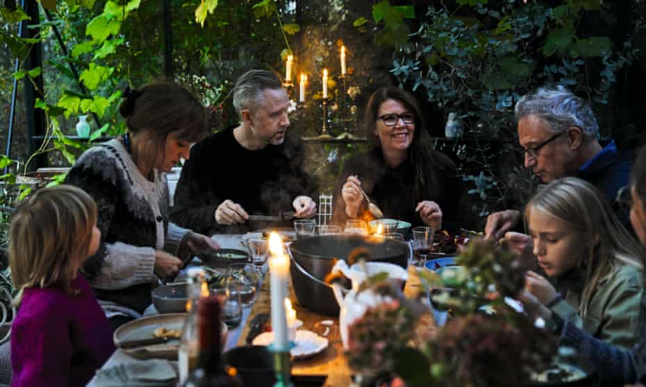Chef Trine Hahnemann (third from right) sitting down for a festive meal.