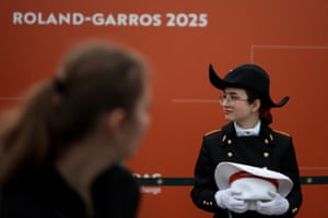 A student of École polytechnique, a science and engineering school in France, wearing the school’s uniform, stands in an alley of the Roland Garros complex