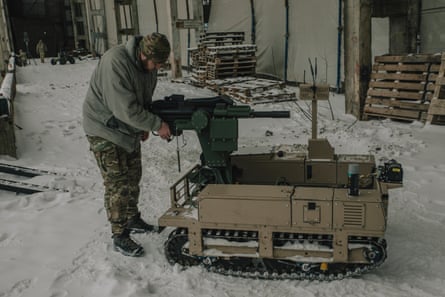An unmanned ground robot is equipped with a remotely controlled machine gun