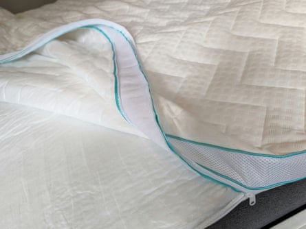 Dunelm Snuggledown mattress topper slightly unzipped showing foam layers.