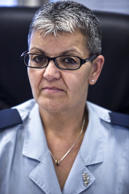 A stern-looking middle-aged woman in a military outfit.