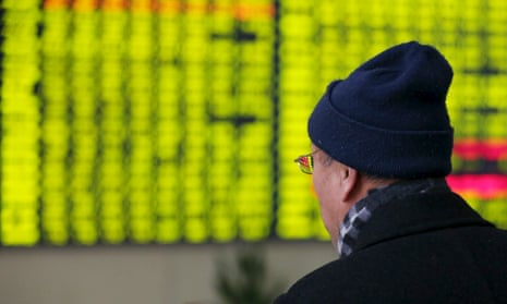 An electronic screen showing stock information at brokerage house in Nantong, China (green shows falling share prices).