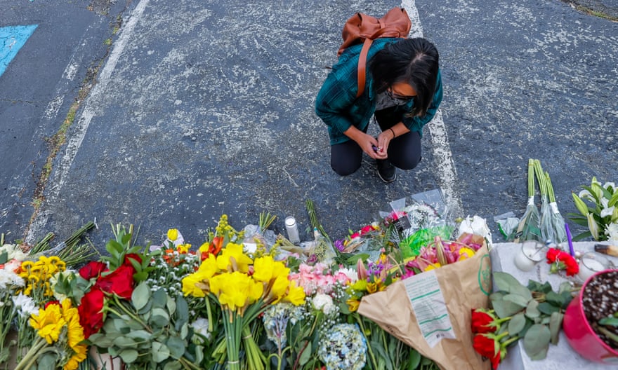 A mourner pauses at the scene of two of the massage parlor shootings in Atlanta, Georgia.