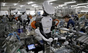 Humanoid robots work side-by-side with employees on an assembly line in Kazo, Japan.