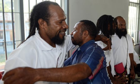 Freed Papuan political prisoner Numbungga Telenggen (L) is hugged by a supporter while Linus Hiluka (2nd R) and Kimanus Wenda (R) look on after a ceremony at a prison presided by Indonesian President Joko Widodo in Abepura located in the restive eastern province of Papua on May 9, 2015. Indonesian President Joko Widodo on May 9 ordered the release of a group of political prisoners in Papua to “create a sense of peace” in a rare conciliatory gesture to the insurgency-hit eastern province. AFP PHOTO / ROMEO GACADROMEO GACAD/AFP/Getty Images
