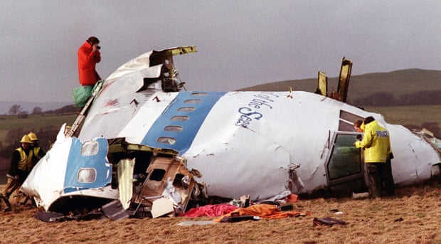 Police and investigators look at what remains of the flight deck of Pan Am 103 on a field in Lockerbie, Scotland in December 1988.