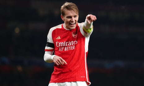 Martin Odegaard points towards his teammates as he celebrates scoring Arsenal’s fifth goal of the game against Lens.