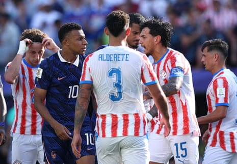 Kylian Mbappe has words with Gustavo Gomez
