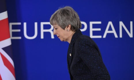 Theresa May walks off stage with union jack and Europe sign in the background