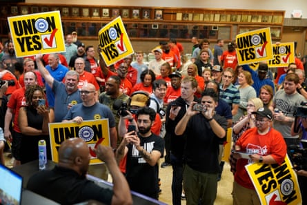 Volkswagen automobile plant employees celebrate winning a vote to join the UAW union