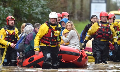 Residents of Nantgarw are evacuated in a rescue boat, after flooding in the Welsh village.