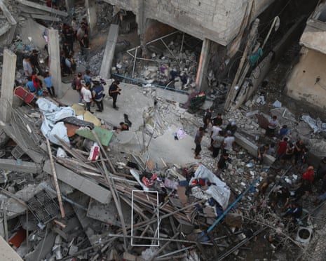 Palestinians inspect the damage, at the site of an overnight Israeli strike on a house, at Shati camp.