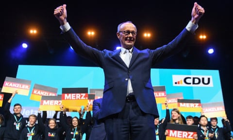 Friedrich Merz gives the thumbs up sign at an election rally