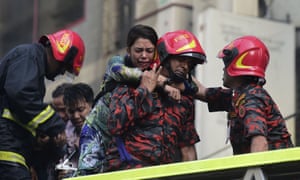 A survivor is rescued by firefighters