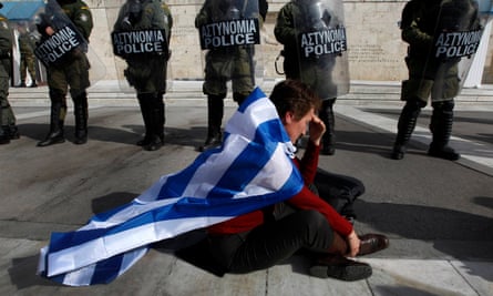 An anti-austerity protester draped in the Greek flag.