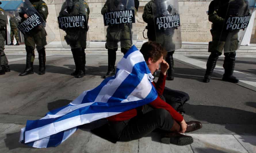 An anti-austerity protester draped in the Greek flag.
