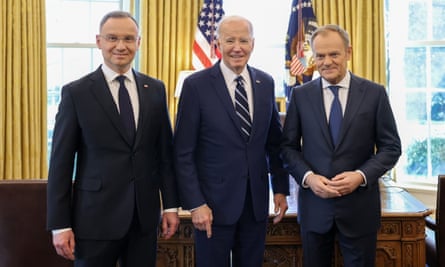 Andrzej Duda, Joe Biden and Donald Tusk stand in front of a desk in the presidential office