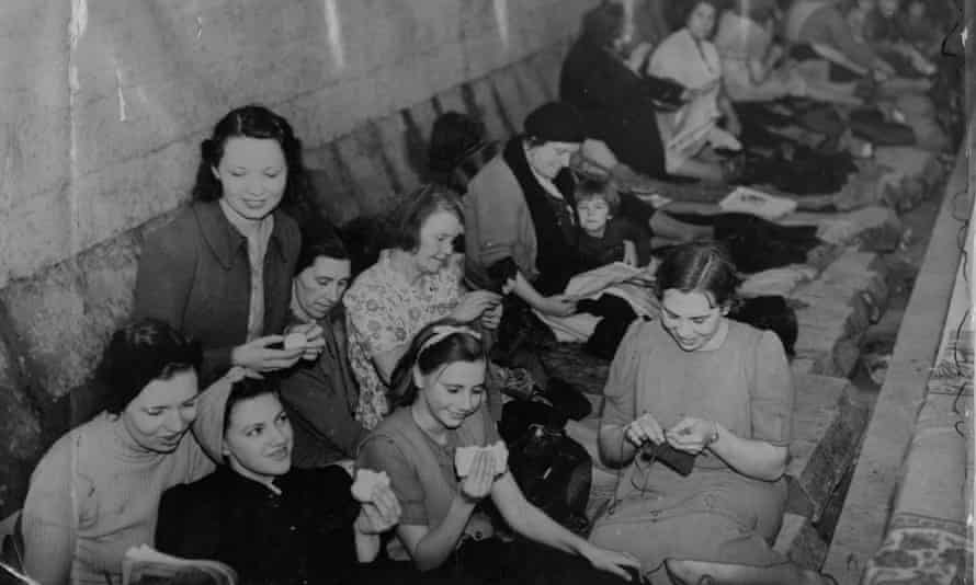 ‘I didn’t worry abut the bombs when I had my head buried in a book’ ... people sheltering, and reading, in Bethnal Green tube station during the second world war.