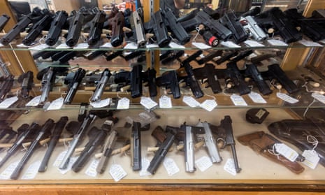 rows of guns behind glass case