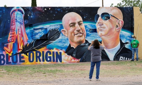 Margarita Moilina, left, and her daughter Ronnie take pictures in front of a mural dedicated to Blue Origin CEO Jeff Bezos in Van Horn, Texas.