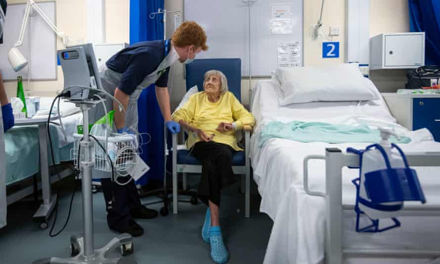 Social care backlash grows after MPs vote through tax plan Doctor with patient in hospital