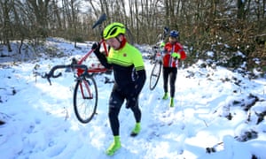 Cyclists carry their bikes through snow in Walderslade, Kent.